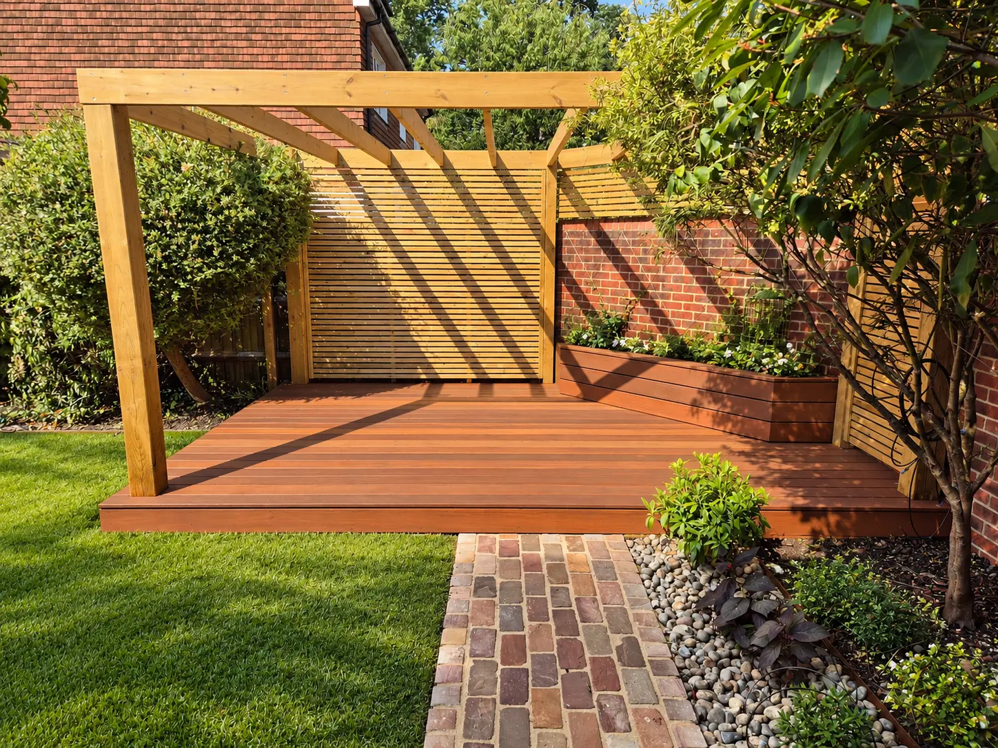 Timber pergola and hardwood deck with slatted screens and planting