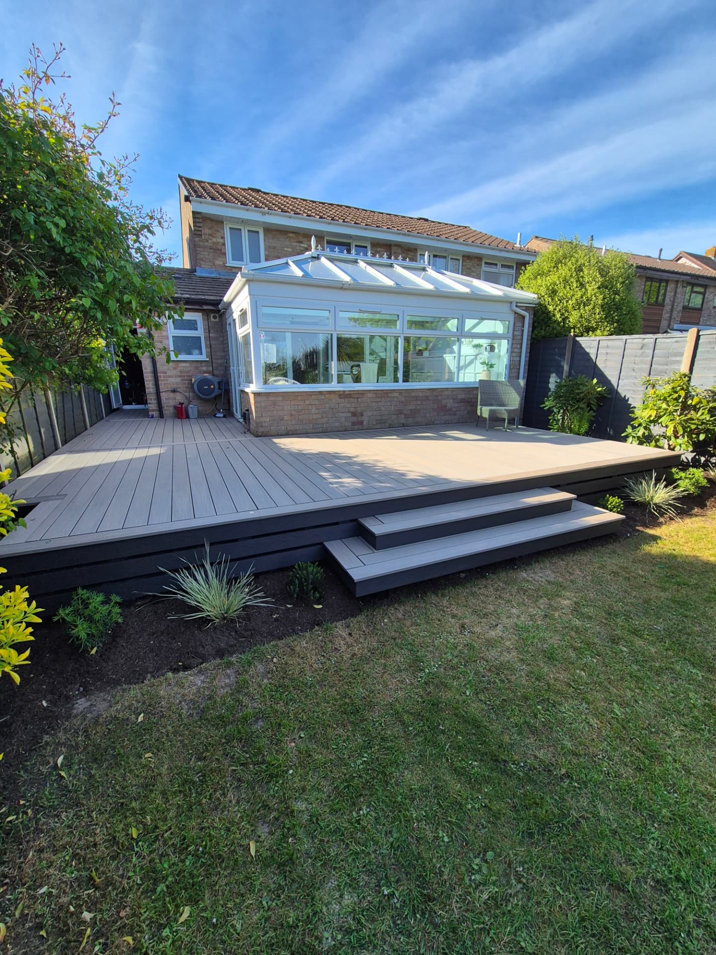 Composite deck with steps and mulched planting bed