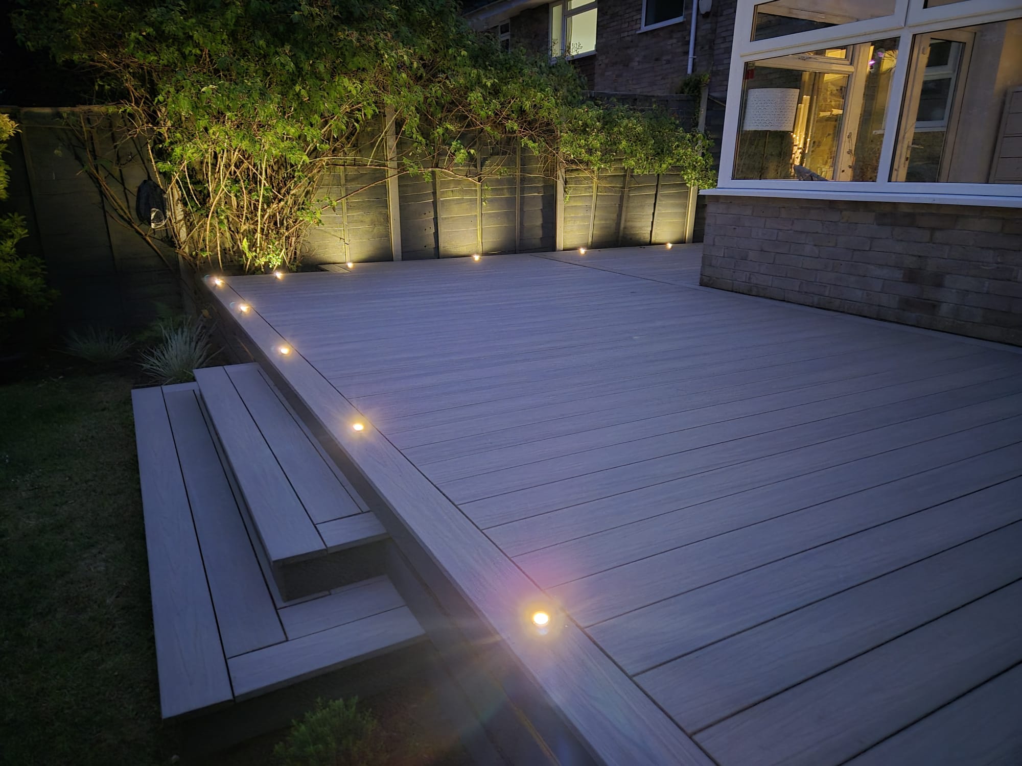 Composite deck with inset deck lights at dusk